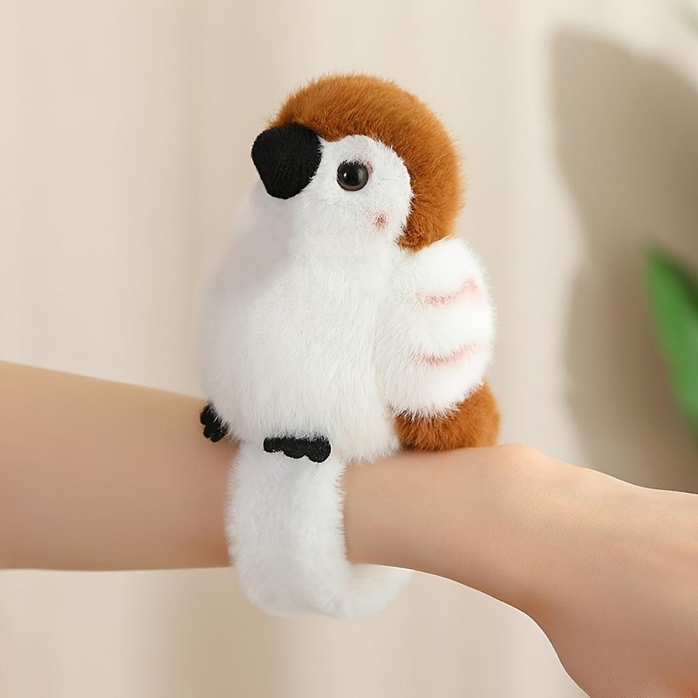 Cute parrot plush wristband with snap closure. Colorful bird-shaped wearable toy for kids, lovely collectible accessory.