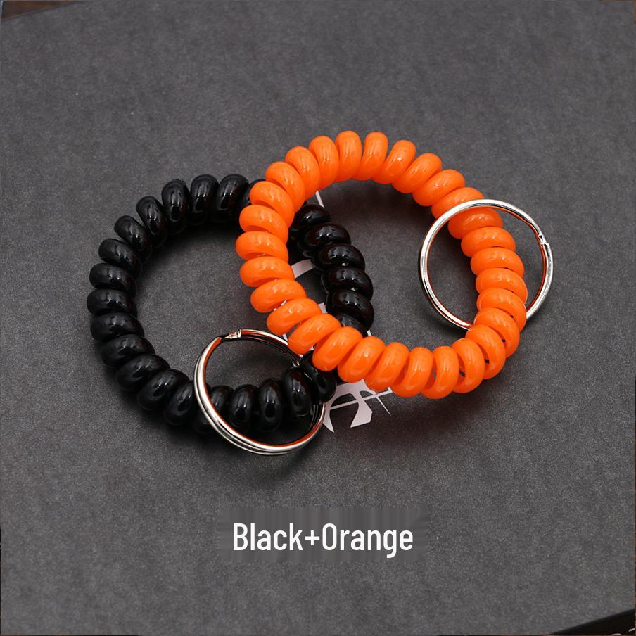 Минималистичный браслет-брелок и резинка для волос в виде пружинного механизма