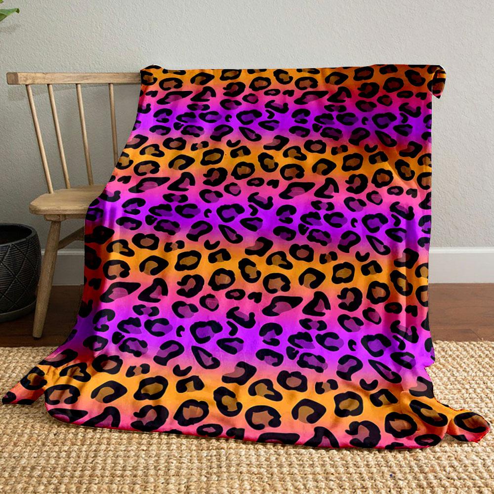 Black leopard spots on a gradient background of orange, pink, and purple. for all seasons blanket lunch break throw gift