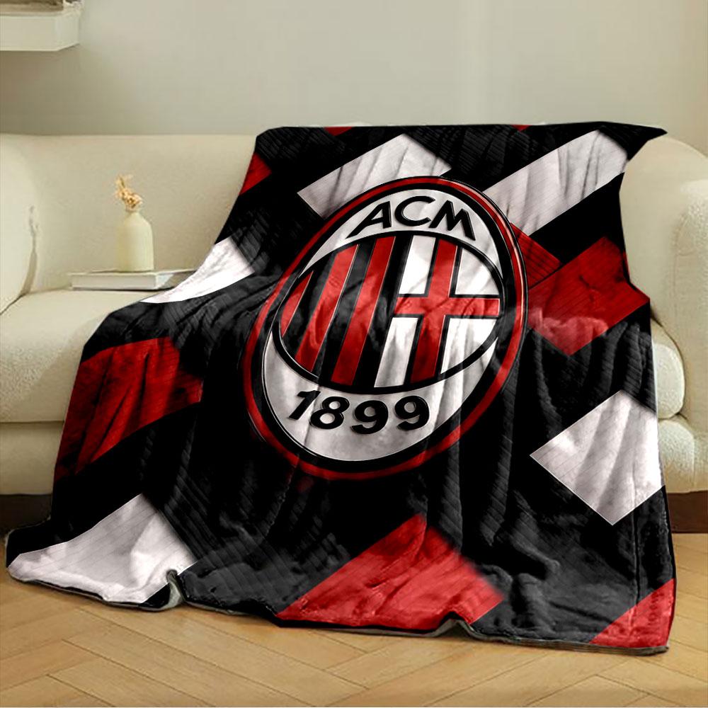 Interwoven red, black, and white strips with an oval emblem in the center. for all seasons blanket lunch break throw gift