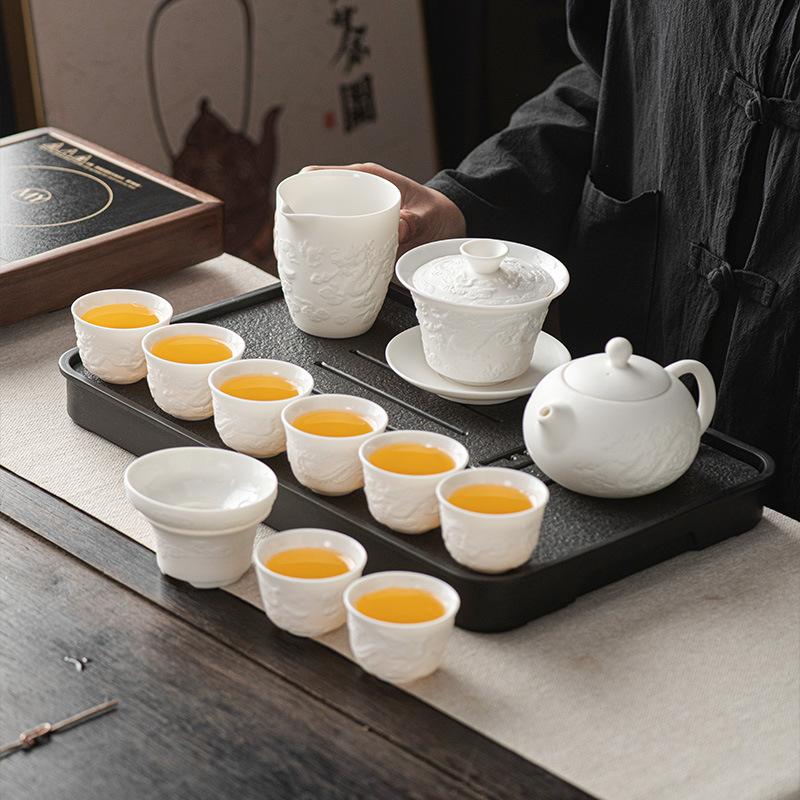 Suet jade porcelain Kung Fu tea set, household full set of ceramic cover bowl tea cup relief tea business gifts