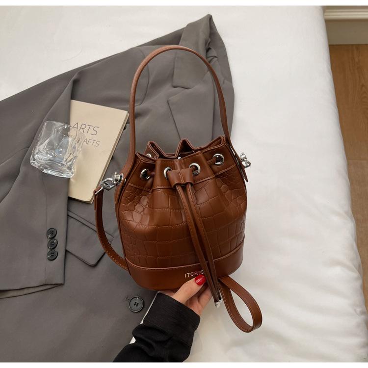 Модная женская сумка 2025 новая сумка-ведро через плечо в иностранном стиле с ремешком-помпой, нишевая сумка в стиле ретро с каменным узором