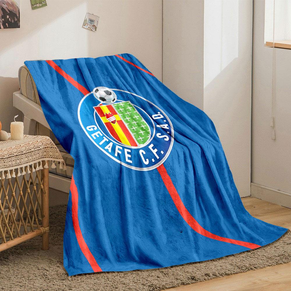 A blue background with red diagonal lines and a football club crest. for all seasons blanket lunch break throw gift