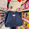 Waterproof Foldable Grocery Tote Bag with Large Capacity and Eco-Friendly Drawstring Design.