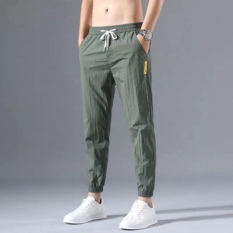 2023 Men's Korean-Style Ice Silk Casual Pants, Quick-Drying, Trendy, Loose-Fit Nine-Point Sports Pants for Summer.
