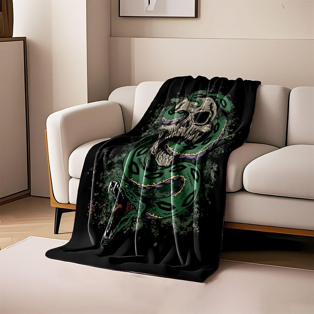 A green snake coiled through a skull with an open mouth in a dark theme. for all seasons blanket lunch break throw gift