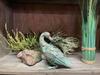 A unique castle decoration, a metal duck in green and gold.