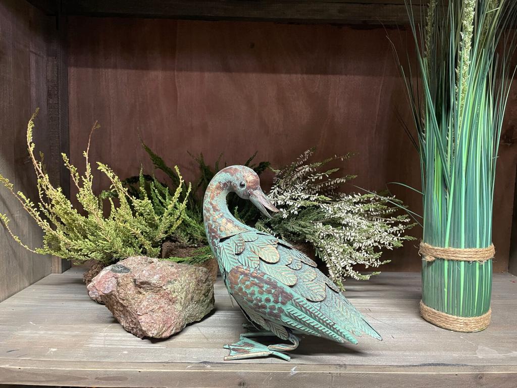 A unique castle decoration, a metal duck in green and gold.