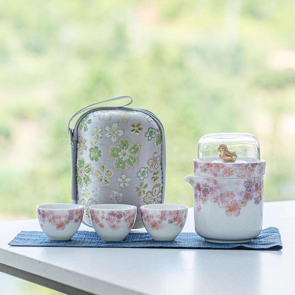 White Porcelain Floral Travel Tea Set: Includes One Pot, Three Cups, and Portable Bag.