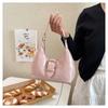Solid color crescent-shaped hobo bag with metal D-ring embellishment, elegant underarm bag, versatile women's handbag for dates and everyday wear.