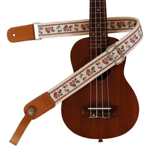 This is a genuine leather ukulele strap with a vintage floral embroidery, an original design by MUSIC FIRST. It is a ukulele shoulder strap with a gen