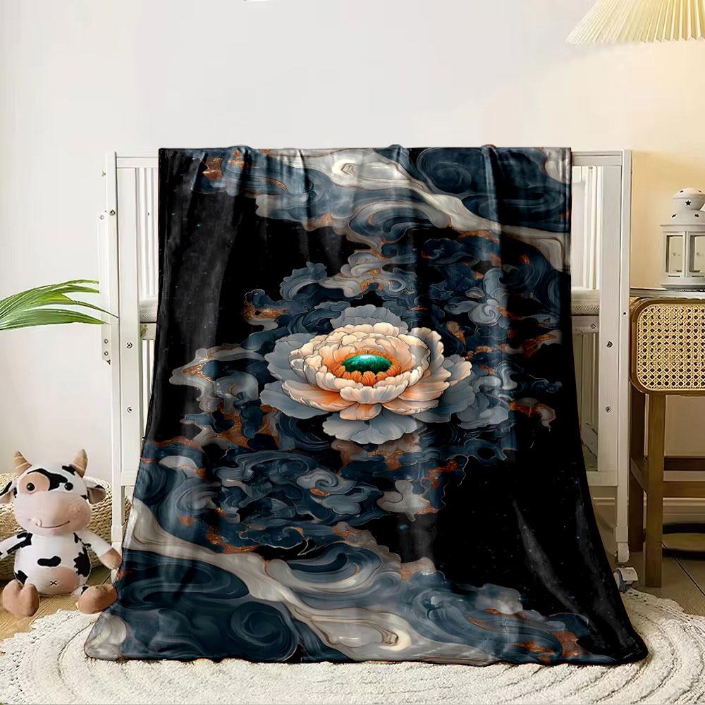 A central flower surrounded by swirling, marble-like dark patterns. for all seasons blanket lunch break throw gift