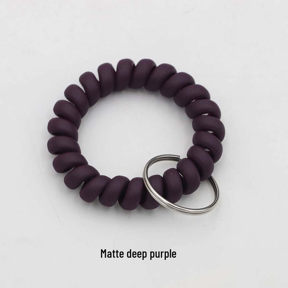 Минималистичный браслет-брелок и резинка для волос в виде пружинного механизма