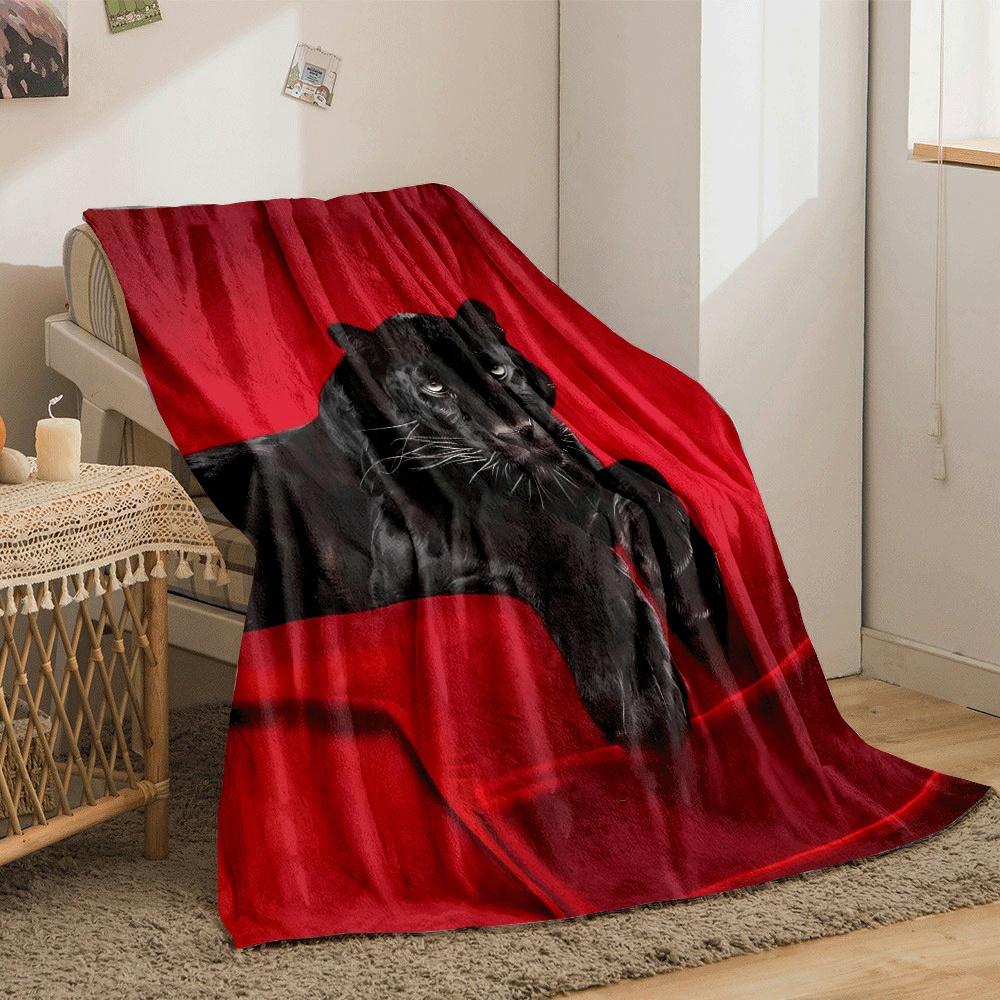 A black panther resting on a vivid red surface with a bold contrast. for all seasons blanket lunch break throw gift