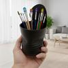 Black flowerpot in the shape of a crushed plant can, modern design