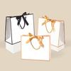 Elegant Gold-Trimmed Bow Gift Bag with Black Edges - Multi-Size Paper Tote for Clothing Stores