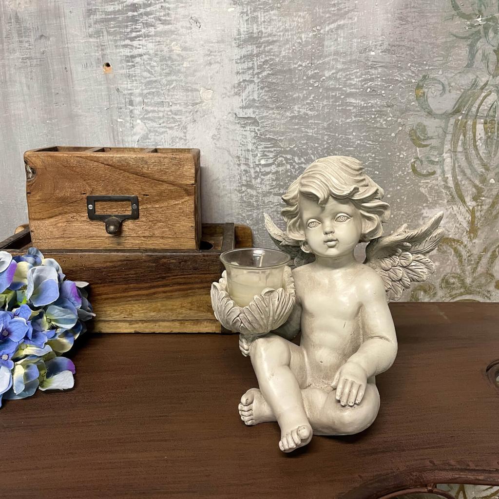 White angel sculpture with a candle