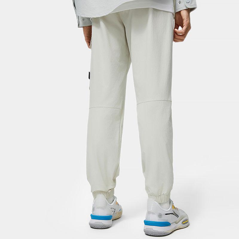 Мужские спортивные брюки Li Ning Wade Series, однотонные, зауженные, с несколькими карманами, плетеные, серебристо-серые, AYKU013-2