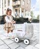 Wicker doll stroller with white embroidered bedding - natural