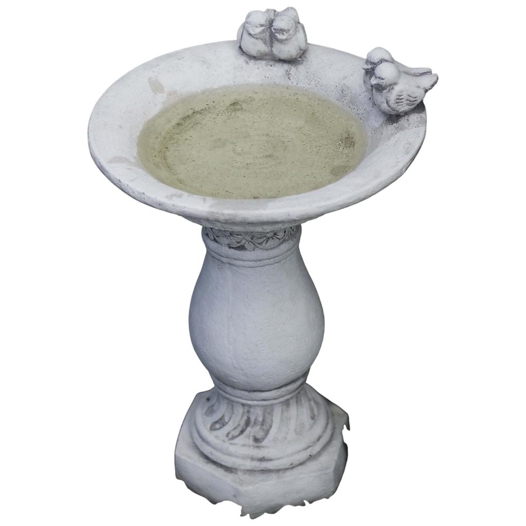 Concrete bird waterer on a column for the garden