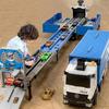 Transforming Truck Transporter with Flashing Lights and Launching Race Track, 8 Die-Cast Cars Included, Friction Push and Pull-back Operation