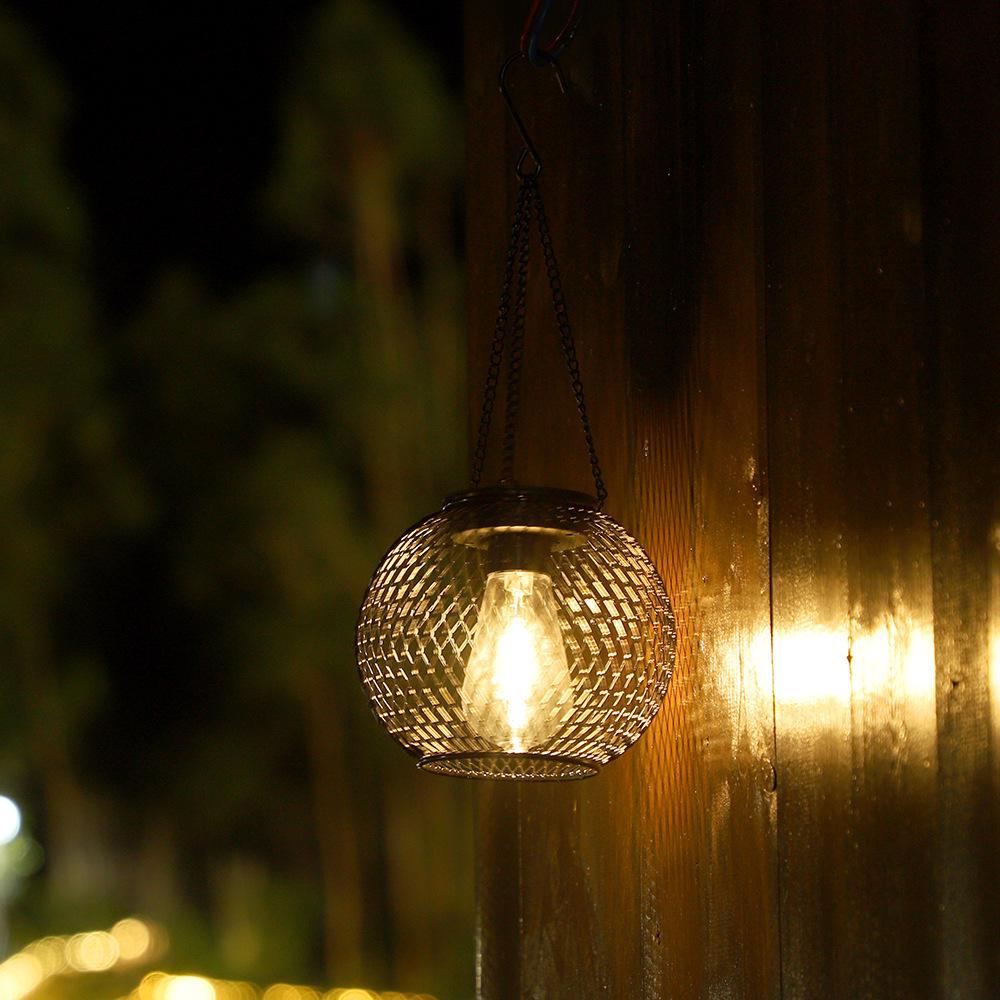 Solar Wrought Iron Lantern Light: Retro Mesh Pendant for Outdoor Garden, Courtyard, and Balcony Ambiance.