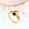 Ornate Black Onyx Crown Ring: Gold-toned Jewelry with a Round Black Cabochon and a Delicate Lotus or Tiara-style Setting.