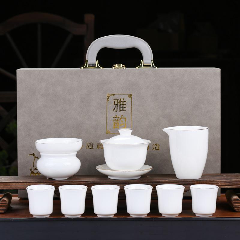 Dehua suet jade kung fu tea set, white porcelain cover bowl painted gold tea cup, the whole set of company opening activities