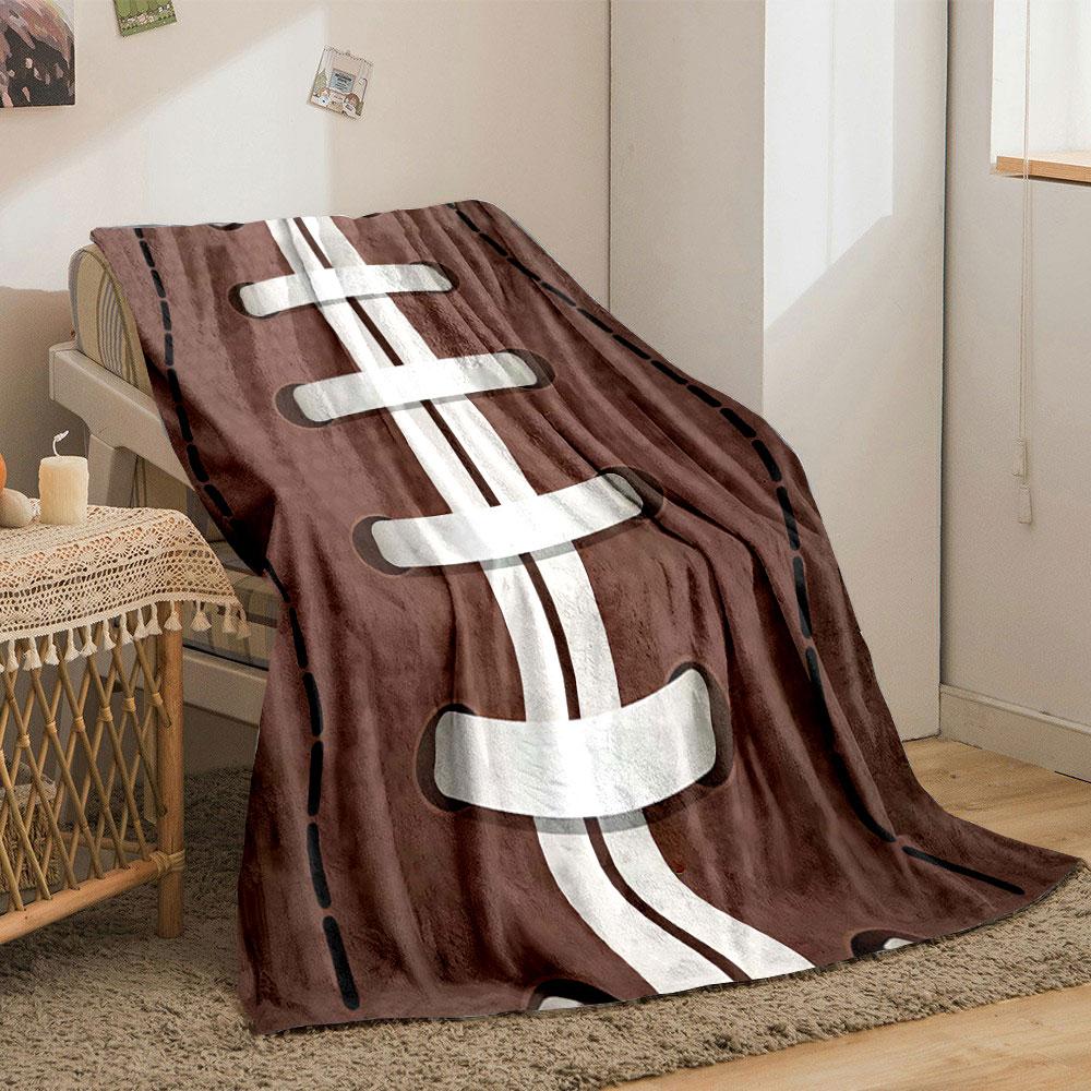 White laces on a brown football with dotted texture and stitched lines. for all seasons blanket lunch break throw gift