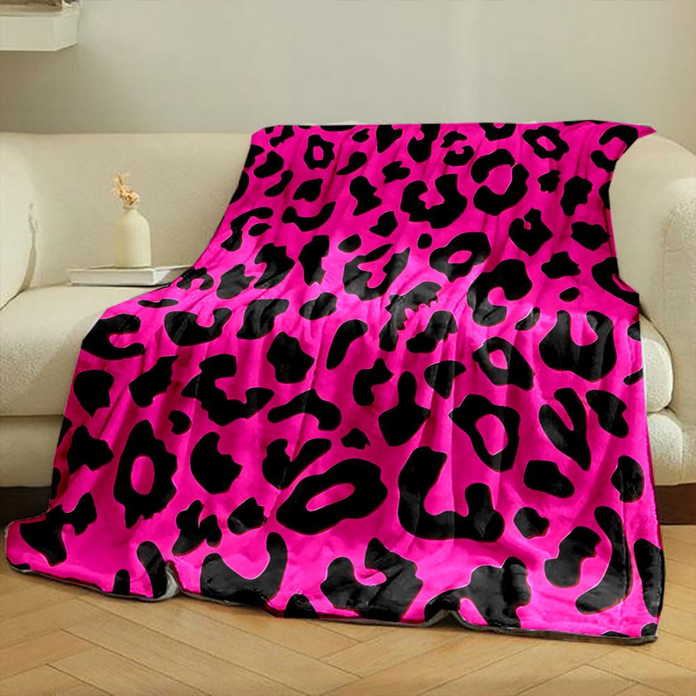 The pattern features irregular black leopard spots on a bright pink background. for all seasons blanket lunch break throw gift