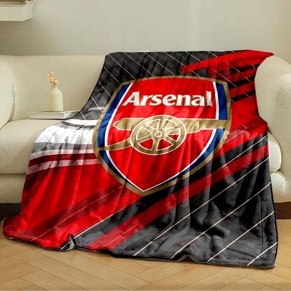 Diagonal stripes in shades of black, red, and white behind a shield logo. for all seasons blanket lunch break throw gift