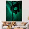 A silhouetted figure performing pole acrobatics under green lighting. Patterned tapestry for bedroom and living room home decor