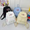 Japanese Student Casual Backpack with Embroidered Puppy Design, Drawstring Closure, and Matching Small Bag for Daily Use.