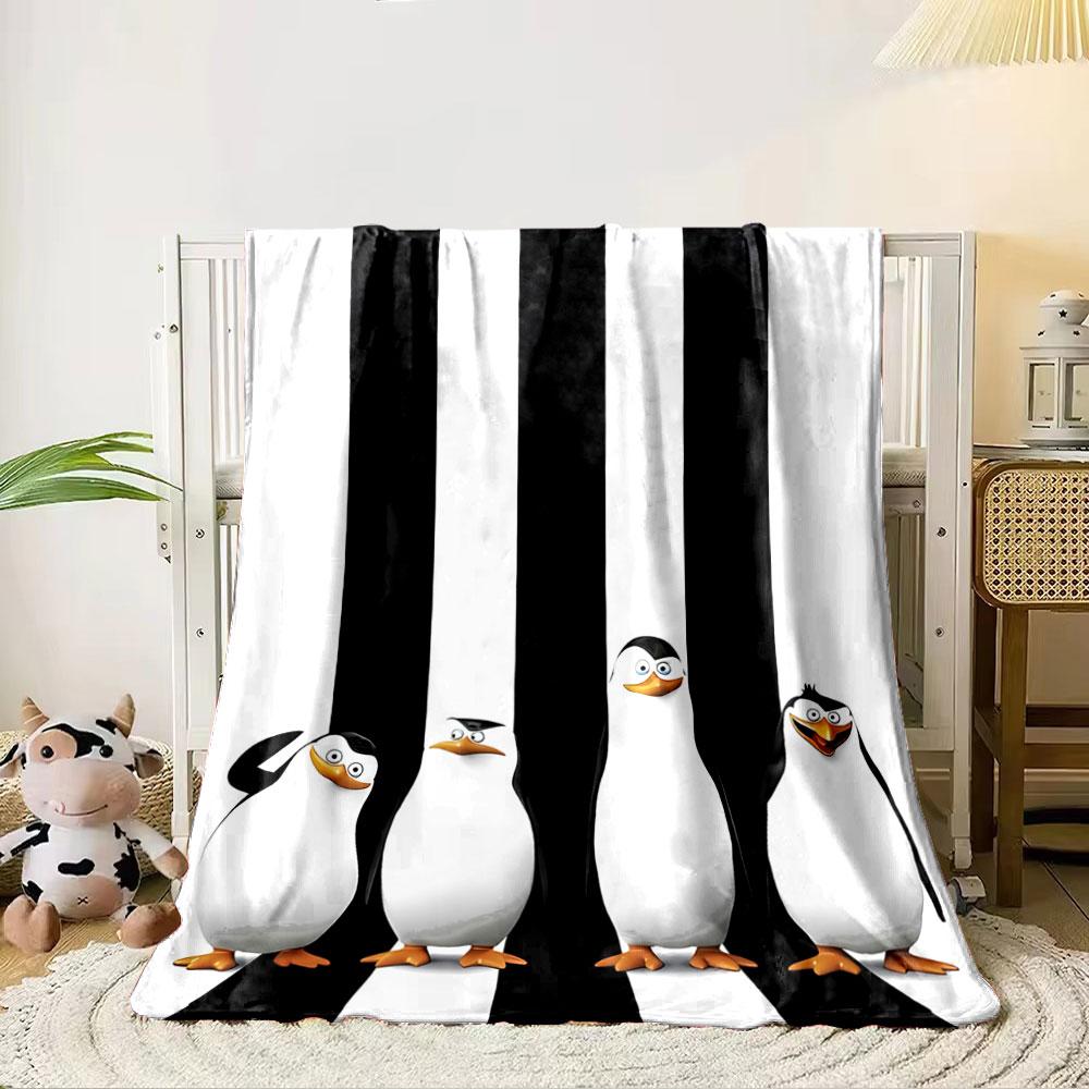Four cartoon penguins stand against vertical black-and-white stripes. for all seasons blanket lunch break throw gift