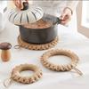Stylish, heat-resistant straw trivet with hooks, perfect for iron kettles, pots, earthenware pots, and other ironware. A simple, decorative accessory