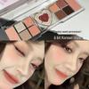 Heartbeat Twelve-Color Heart-Shaped Eyeshadow Palette: Pearlescent, Fine Glitter, Matte, Blush, Highlighter for Enhanced Complexion.