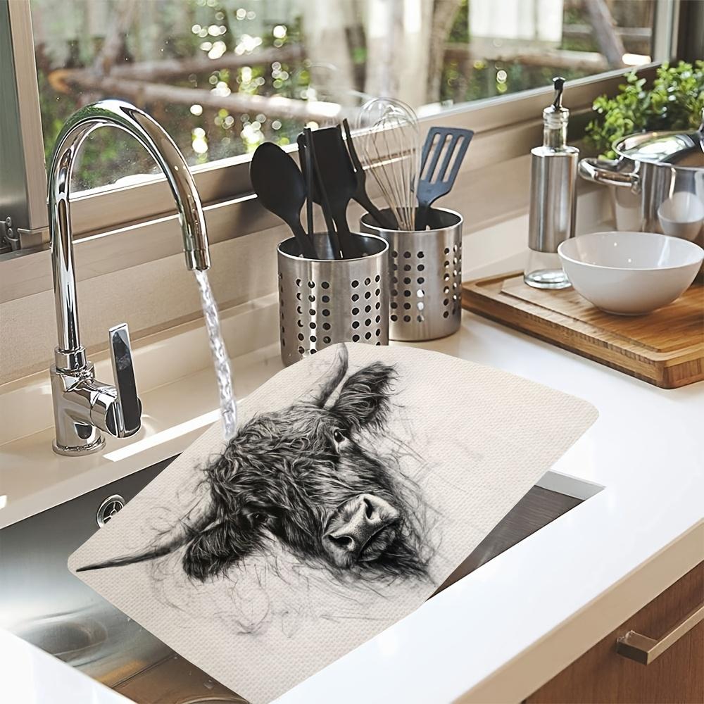 A set of 4 placemats depicting fluffy Highland cattle, perfect for farmhouse-style decor. These washable placemats are suitable for outdoor use and