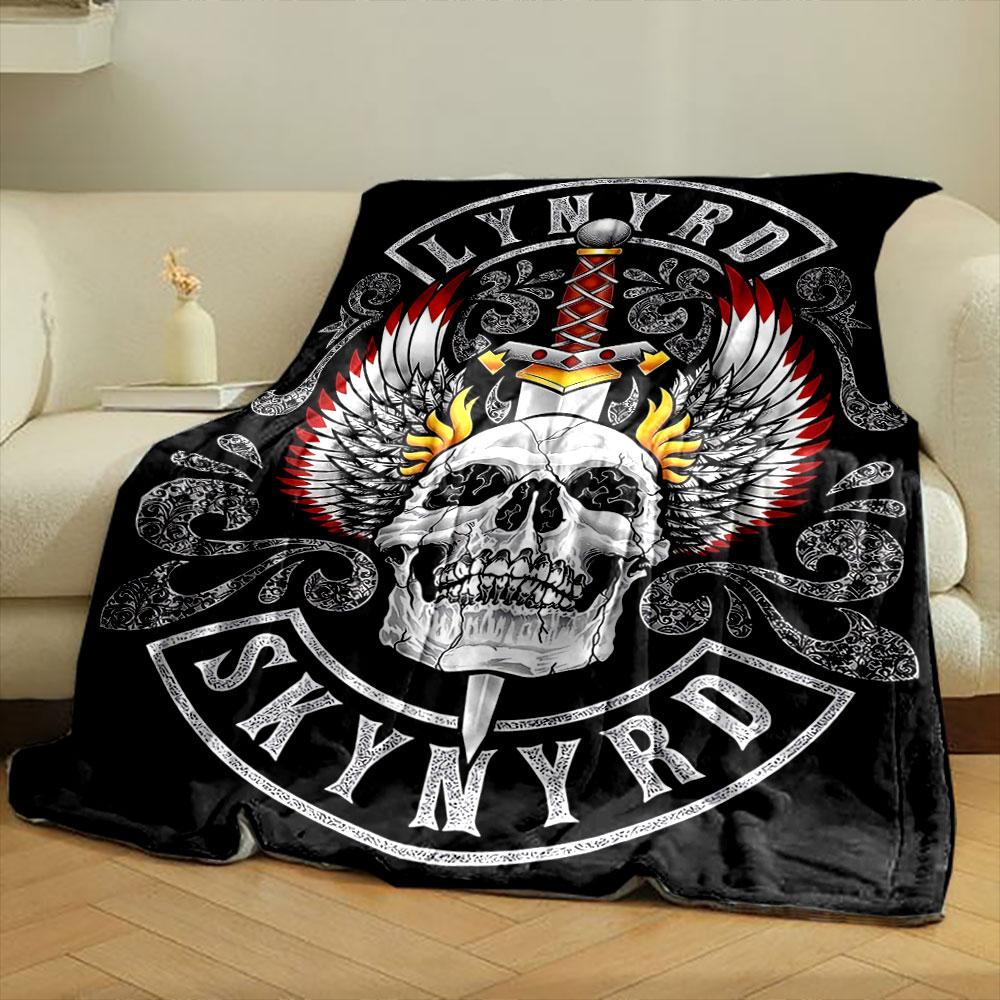 A skull with flaming wings and a sword, framed by intricate patterns. for all seasons blanket lunch break throw gift