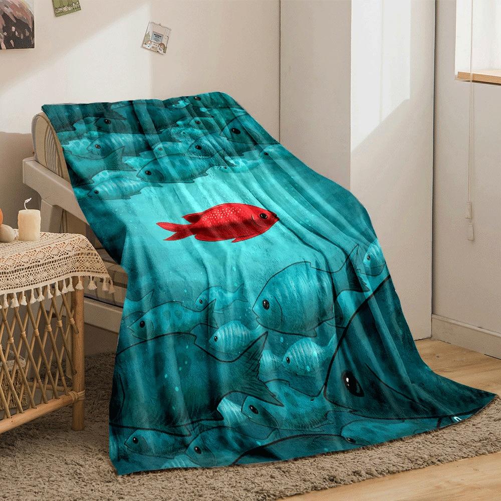 A single red fish contrasts against a large group of blue-green fishes. for all seasons blanket lunch break throw gift