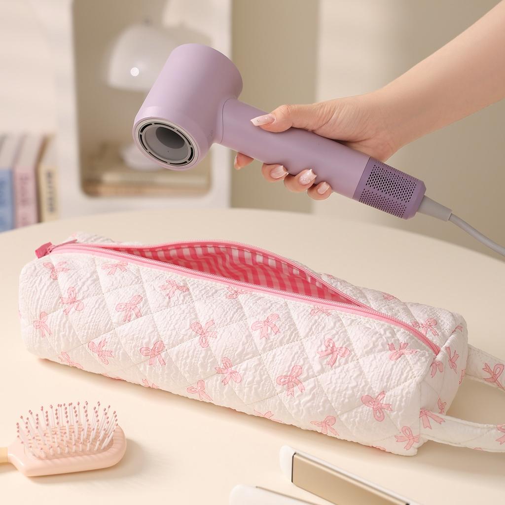 Bow-design hair tool storage bag with zipper. Dustproof for hair dryers and styling tools, ideal for travel and daily use.