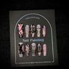 Long pink holographic press-on nails, dark-themed iridescent rabbit-design false nails, handcrafted press-on nails.