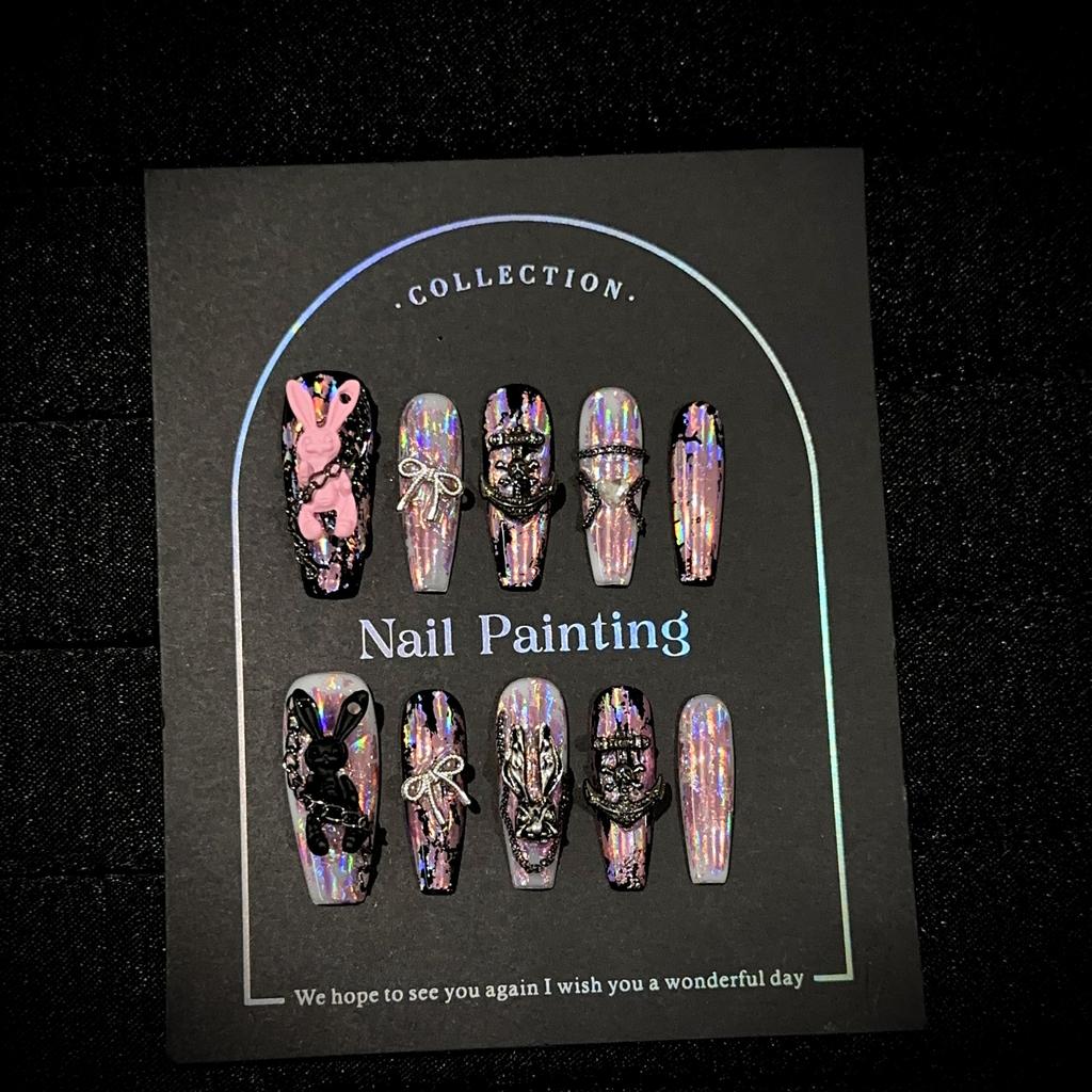 Long pink holographic press-on nails, dark-themed iridescent rabbit-design false nails, handcrafted press-on nails.