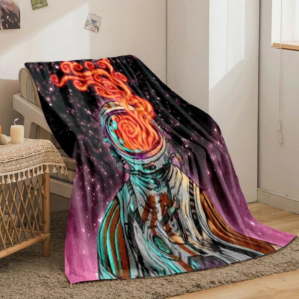 An astronaut's helmet emits swirling fiery patterns against a starry backdrop. for all seasons blanket lunch break throw gift