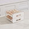 Double-layer 32-grid drawer-style egg storage box made of PET and PP. Space-saving fridge organizer keeps eggs fresh and neatly arranged.