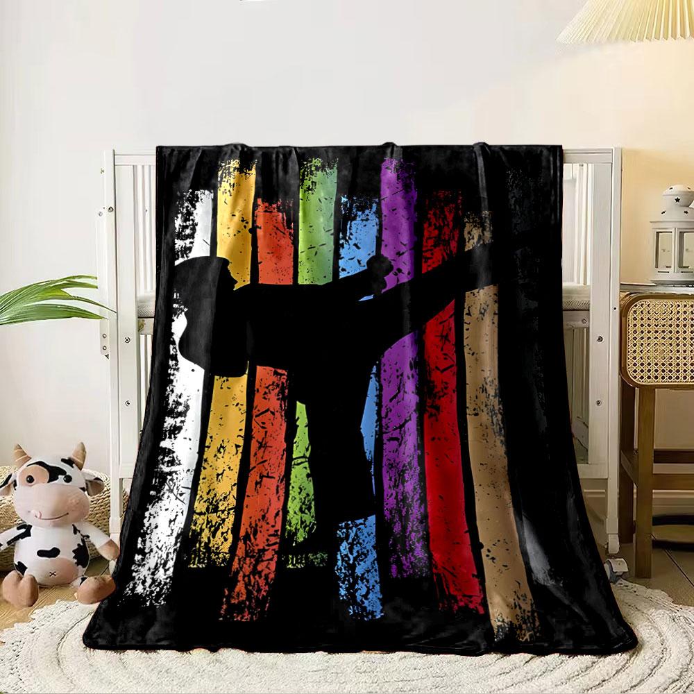 A karate silhouette overlaying vertical, grunge-style colored stripes. for all seasons blanket lunch break throw gift