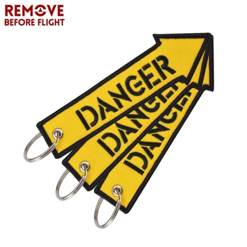 Удалите перед полетом желтый брелок с вышивкой в ​​виде буквы опасности, ремешок для ключей, брелок