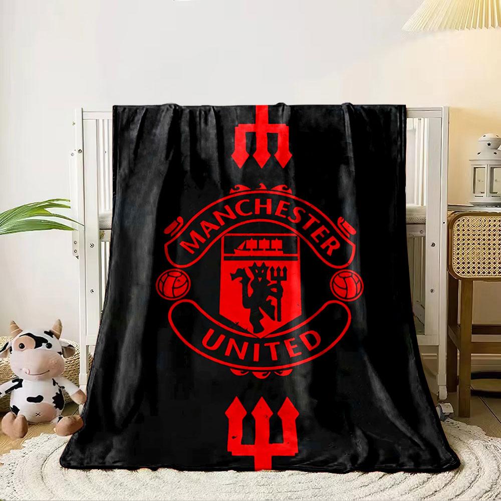 A red Manchester United emblem with tridents on a black background. for all seasons blanket lunch break throw gift