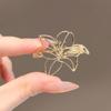 High-End Brooch Women'S Metal Hollow Lily Niche Design Advanced Sense Anti-Light Brooch Pin Buckle Light Luxury