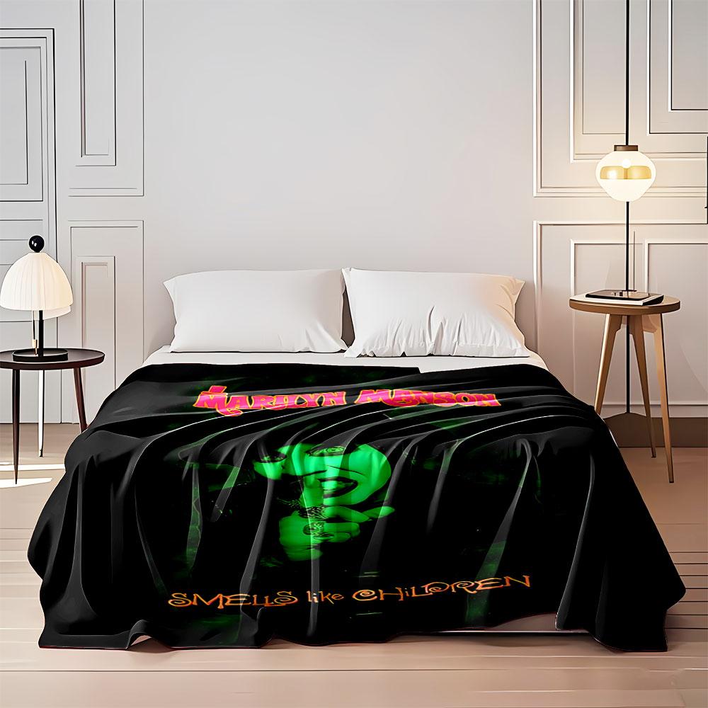 A green-lit figure with a dark hat and makeup, shushing with one finger. for all seasons blanket lunch break throw gift