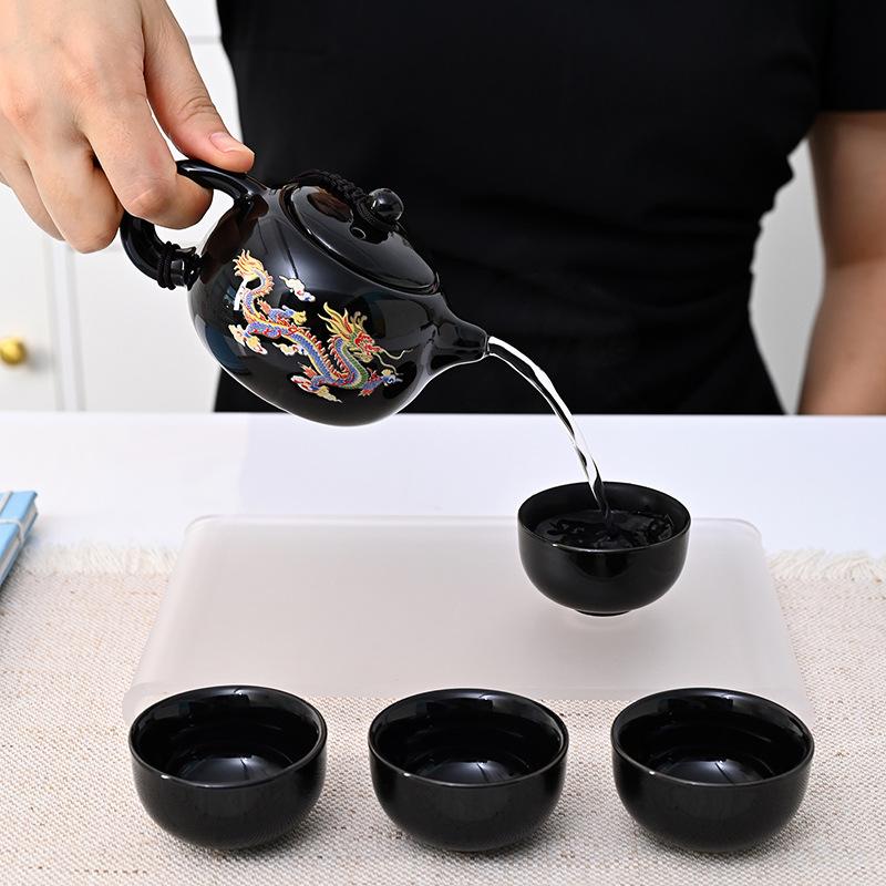 Color-changing dragon and phoenix kung fu tea set, a complete set of cowhide boxes, a pot of four cups of teapots, a gift for making teapots, small
